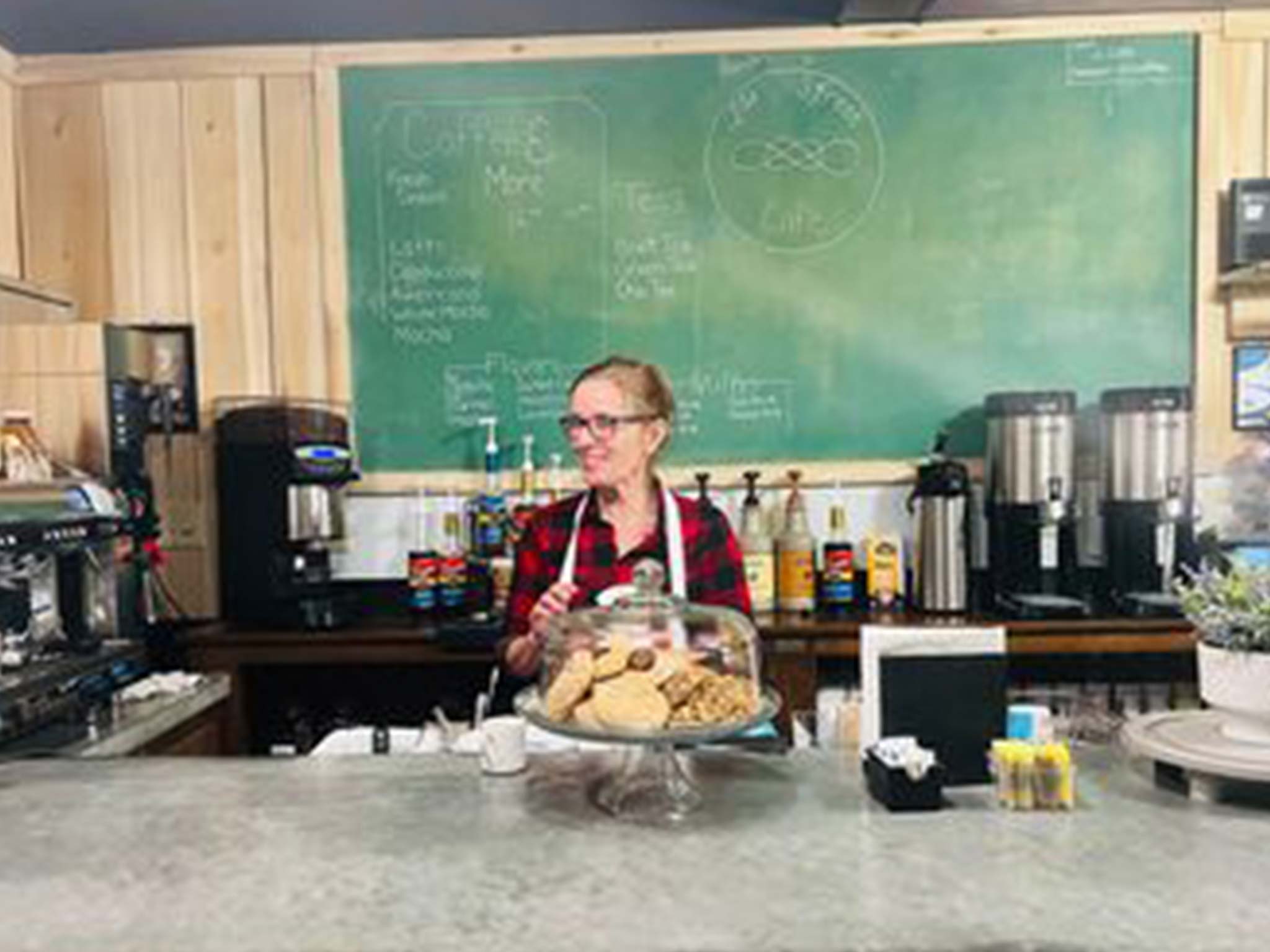 Owner of 1st Street Cafe poses for a photo op on opening day of the coffee shop in Leechburg, PA